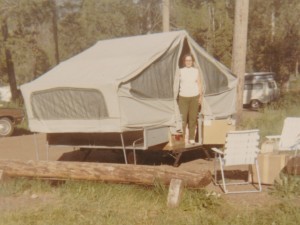 Mom with our first pop-up camper (a rental, like all of them), on the way to Wyoming. Maybe 1970?